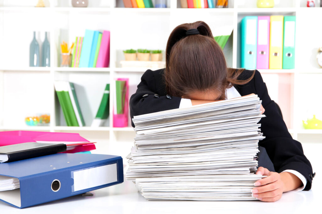 woman with a pile of documents too busy for concord dental care